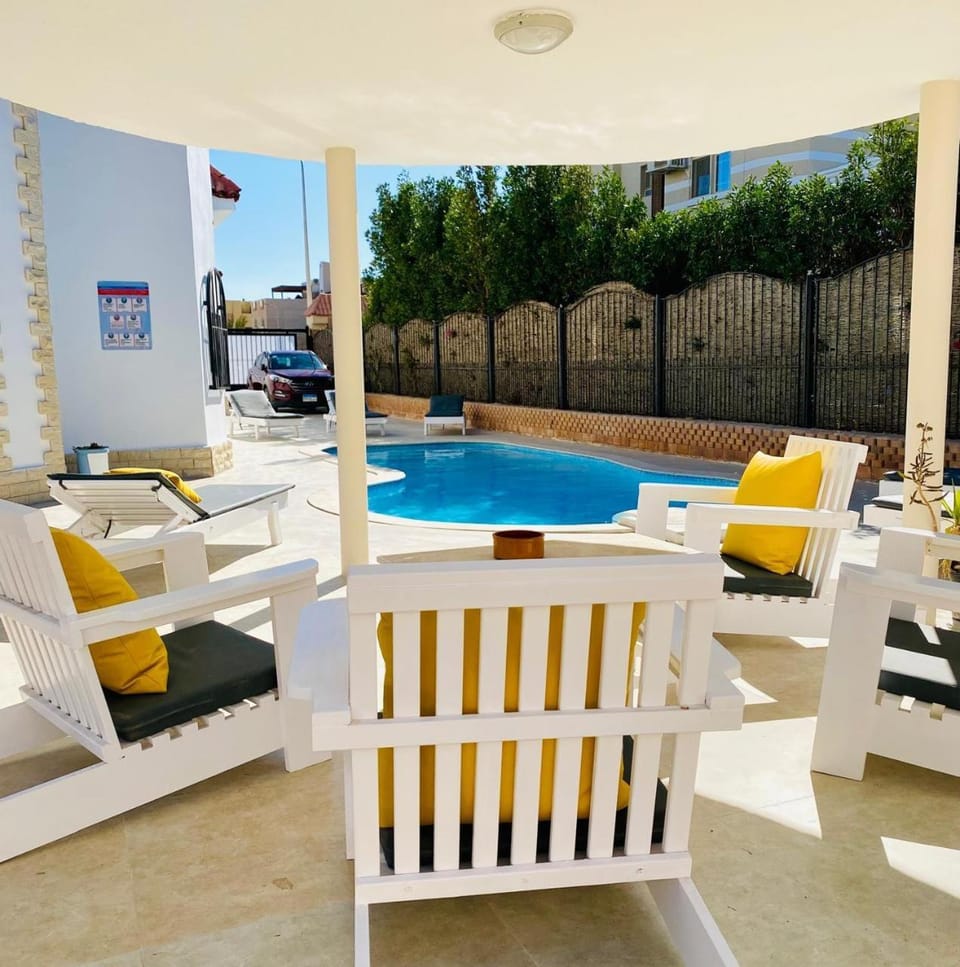 Property building, Patio, Balcony/Terrace, Living room, Seating area, Evening entertainment, Swimming pool