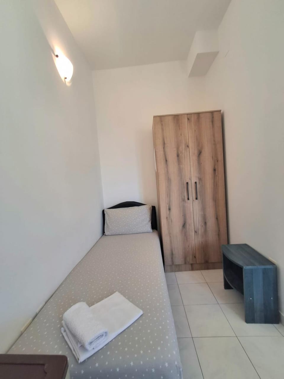 Bed, towels, wardrobe