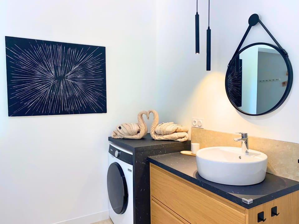 Bathroom, hair dryier, towels, washing machine