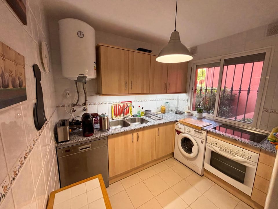 Kitchen or kitchenette, dishwasher, oven, stove, toaster, washing machine