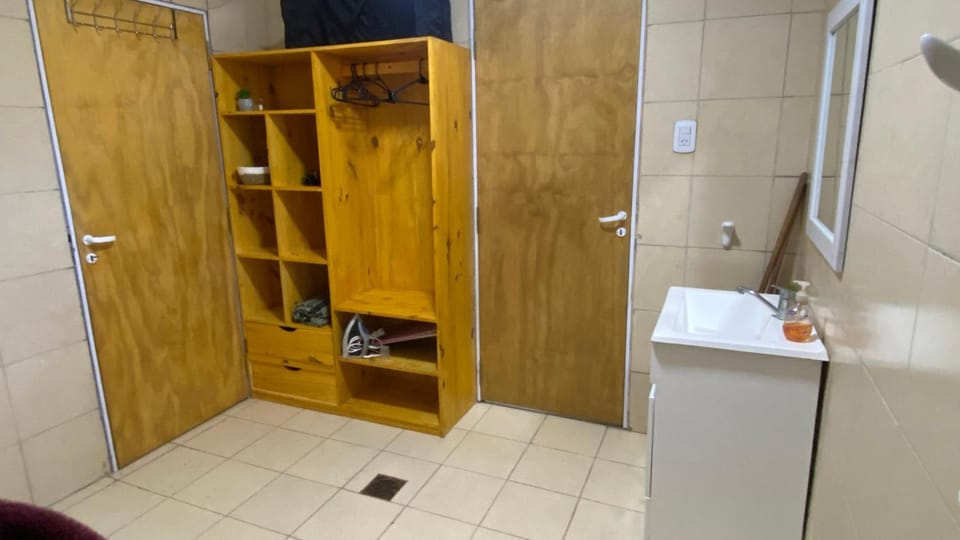 Bathroom, flat iron, hair dryier, towels, wardrobe