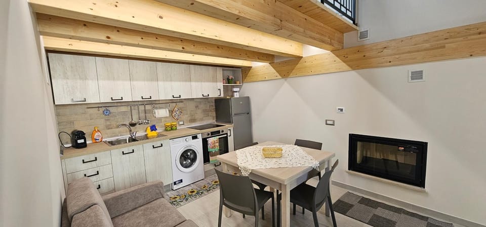 Kitchen or kitchenette, Dining area, fireplace, oven, stove, washing machine