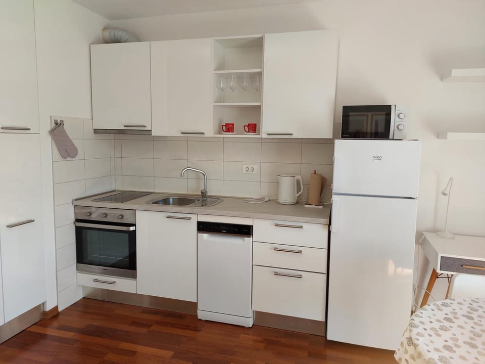 Kitchen or kitchenette, dishwasher, microwave, oven, stove