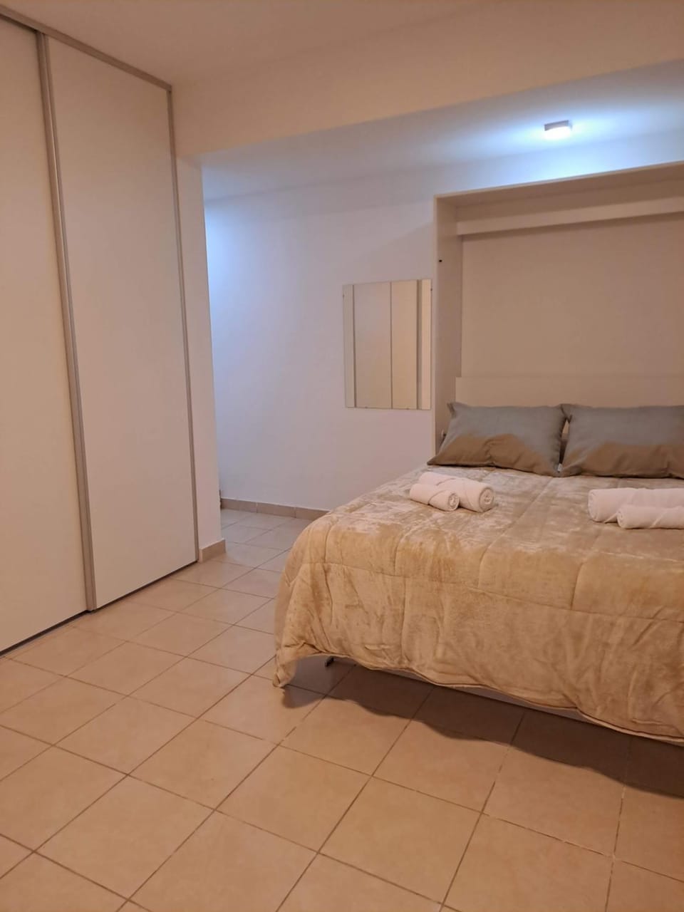 Bed, towels, wardrobe