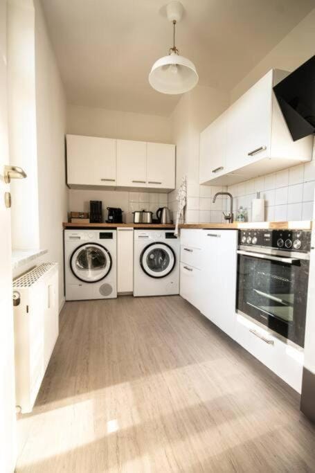 Kitchen or kitchenette, dishwasher, oven, washing machine, dryer