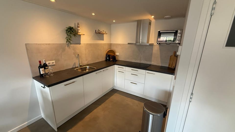 Kitchen or kitchenette, dishwasher, oven, stove