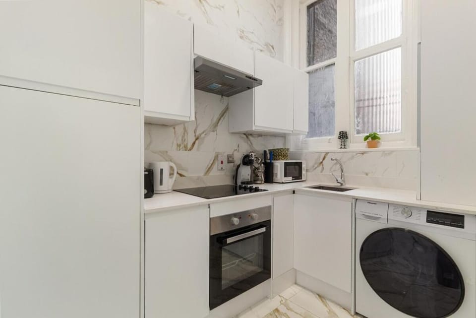 Kitchen or kitchenette, microwave, oven, toaster, washing machine