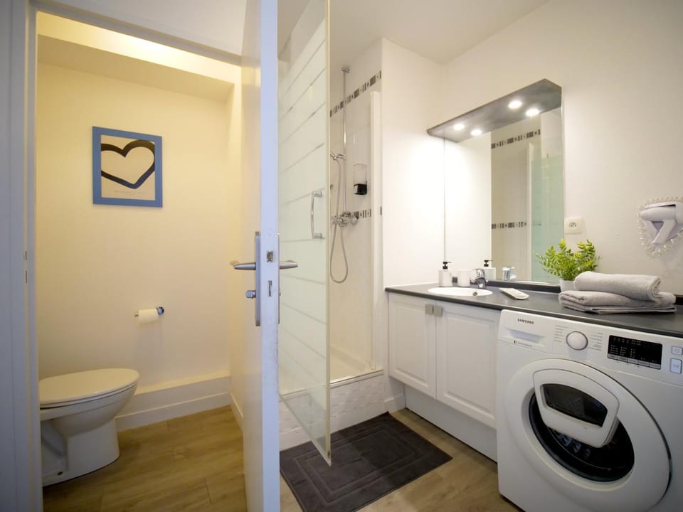 Shower, Toilet, Bathroom, hair dryier, towels, washing machine