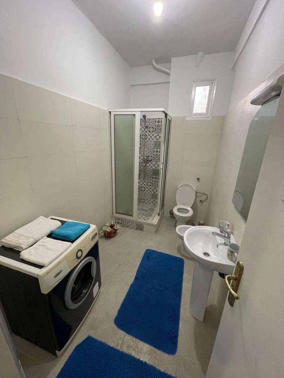 Shower, Toilet, Bathroom, bidet, towels, washing machine, dryer