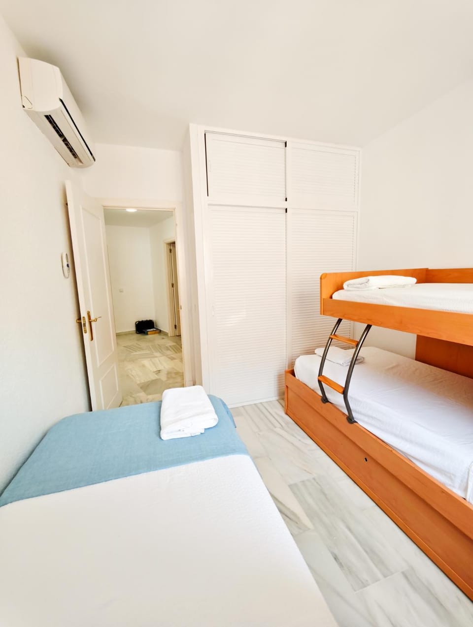 Bed, Photo of the whole room, Bedroom, bunk bed, towels, air conditioner