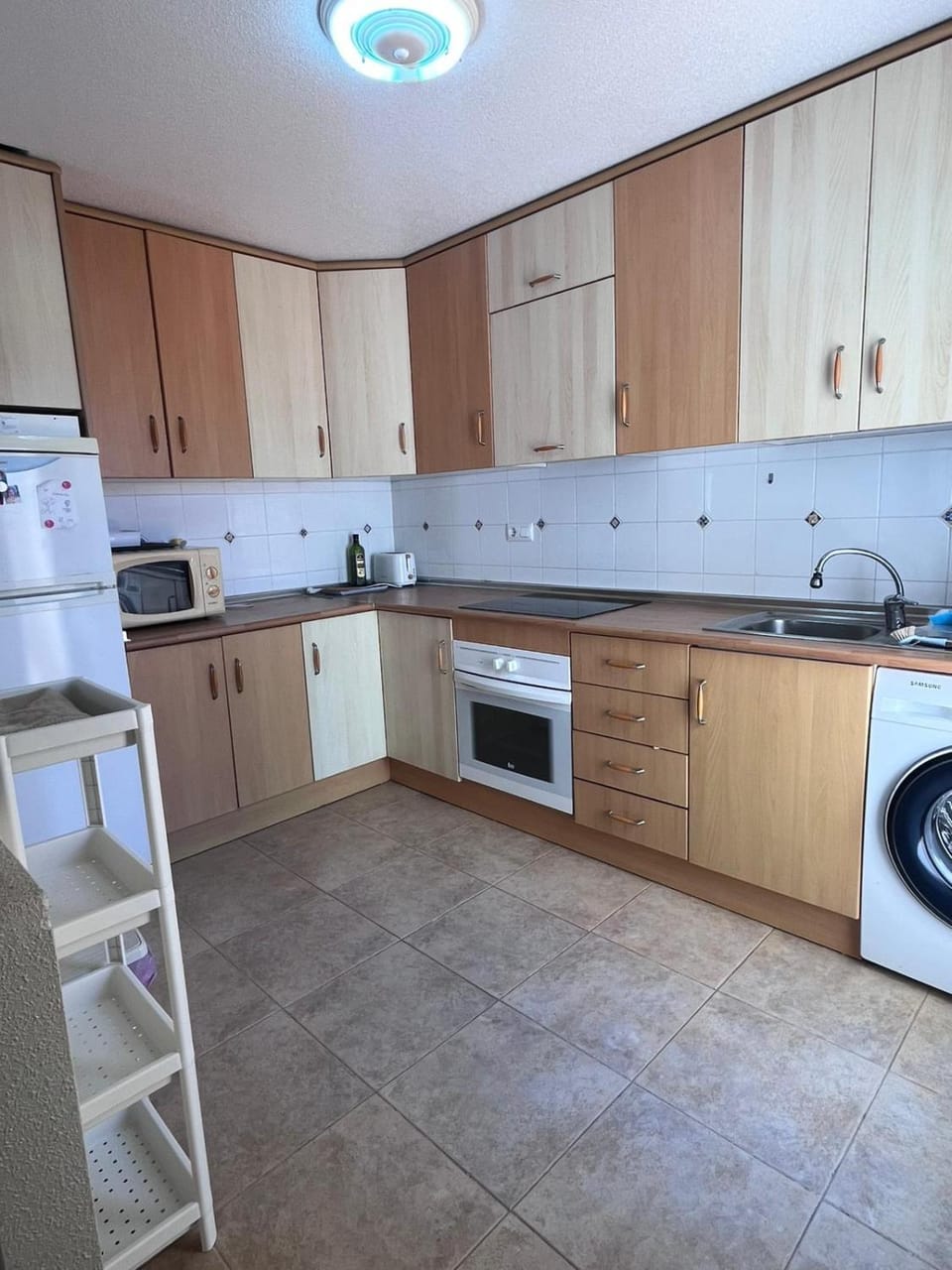 Kitchen or kitchenette, oven, stove, washing machine