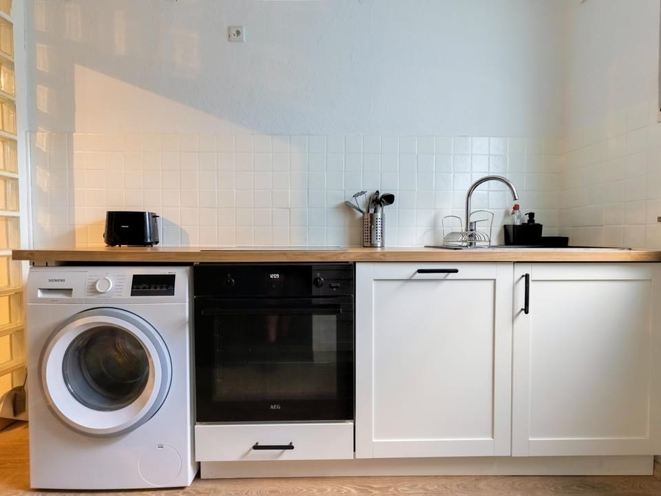 Kitchen or kitchenette, dishwasher, oven, stove, washing machine