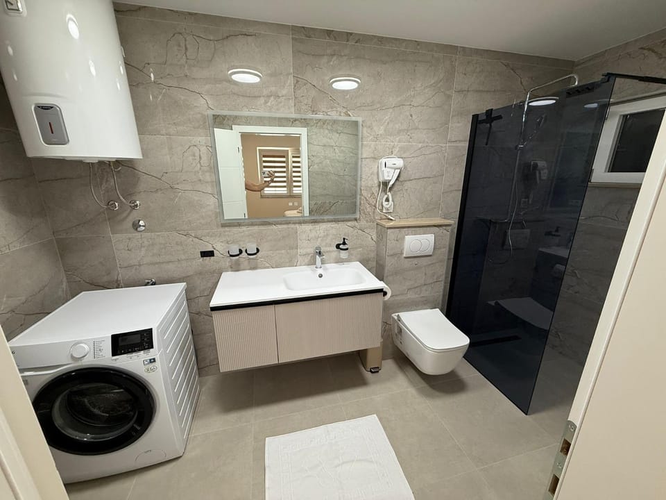 Shower, Toilet, Bathroom, towels, washing machine, dryer