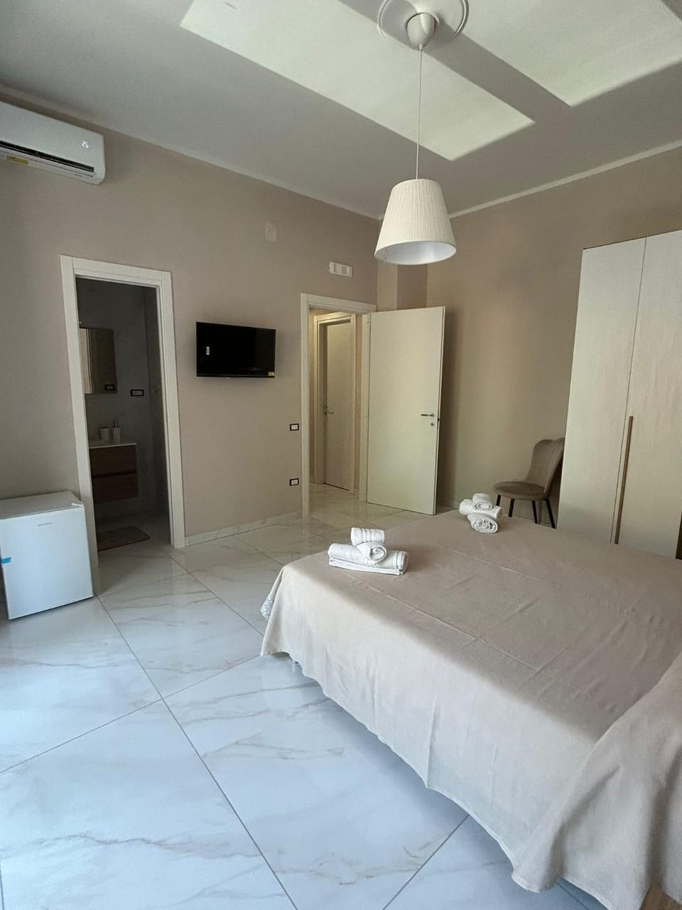 Bed, towels, wardrobe, air conditioner