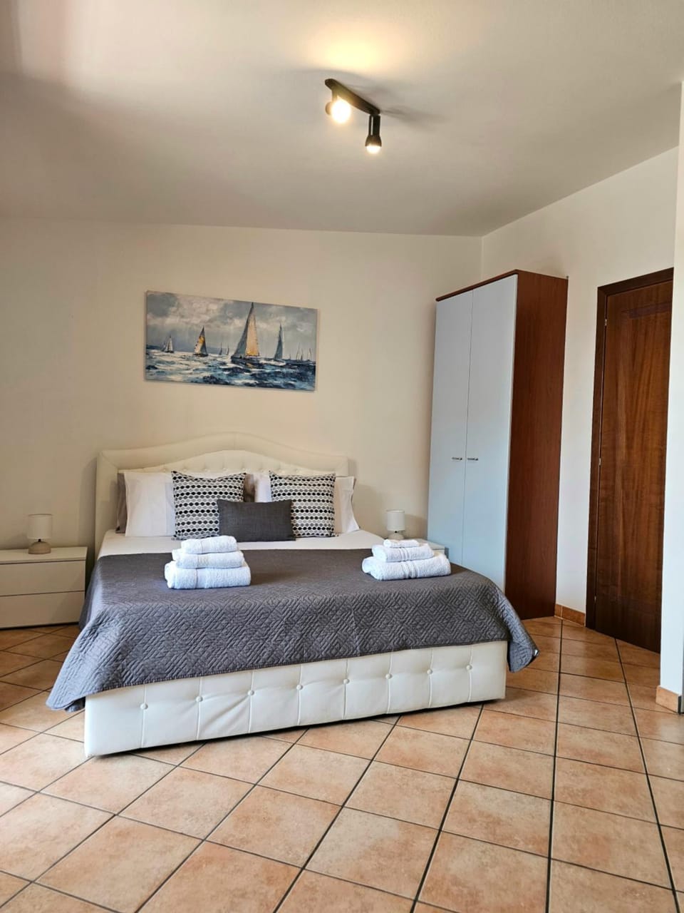Bed, towels, wardrobe