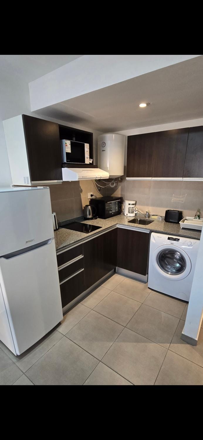 Kitchen or kitchenette, oven, stove, toaster, washing machine