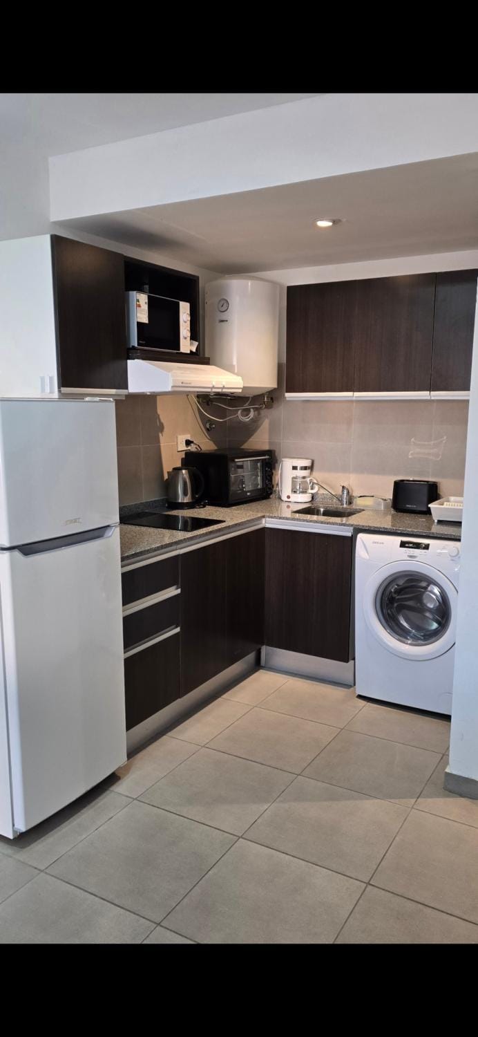 Kitchen or kitchenette, oven, stove, toaster, washing machine