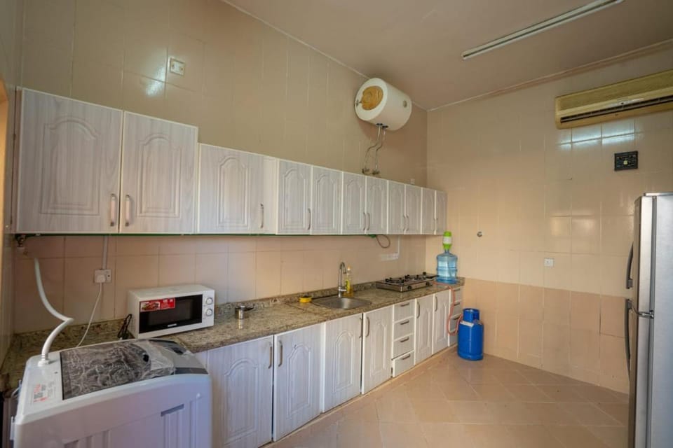 Kitchen or kitchenette, oven, stove, washing machine, dryer, air conditioner