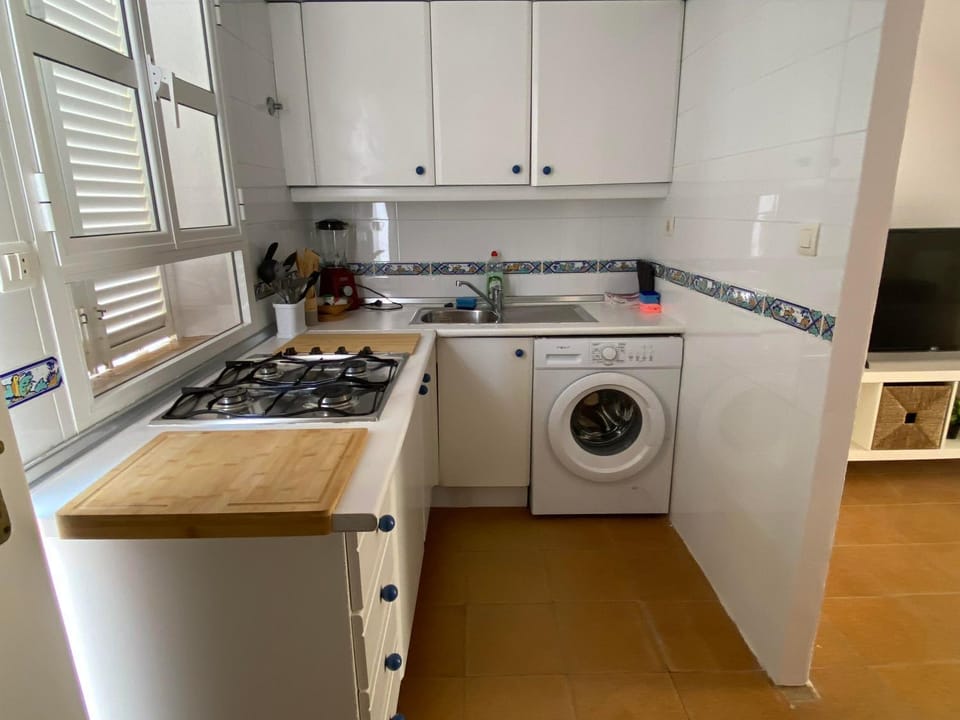 Kitchen or kitchenette, stove, washing machine, dryer