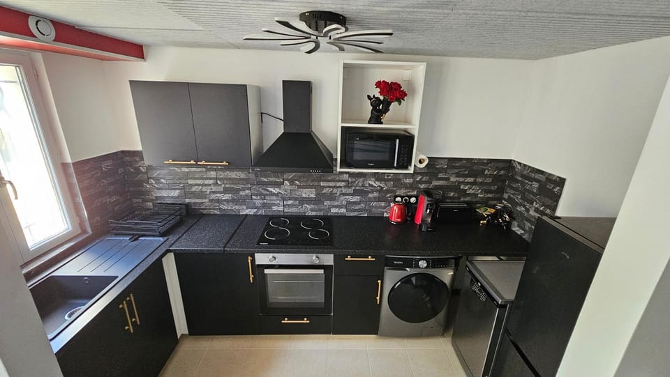 Kitchen or kitchenette, dishwasher, oven, stove, toaster, washing machine