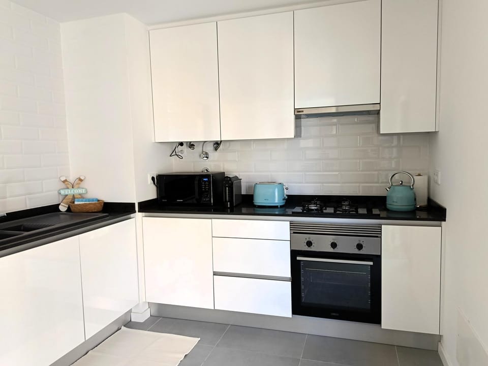 Kitchen or kitchenette, dishwasher, stove, toaster
