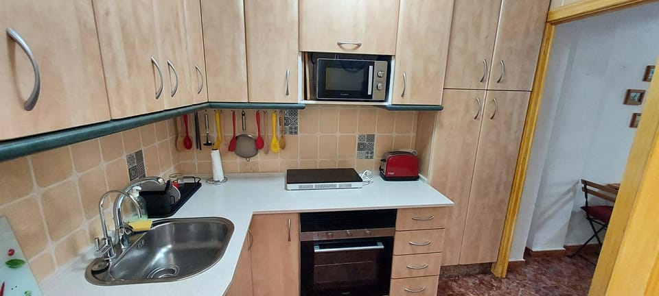 Kitchen or kitchenette, microwave, stove, toaster