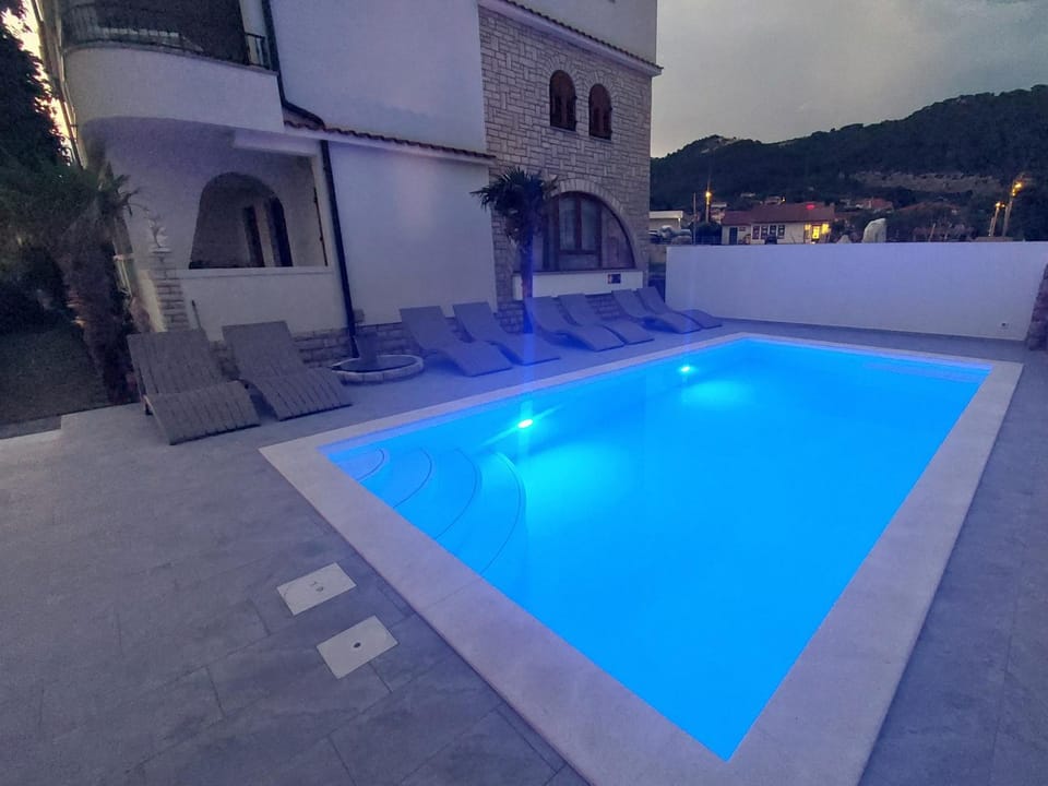 Property building, Night, Pool view, Swimming pool, sunbed