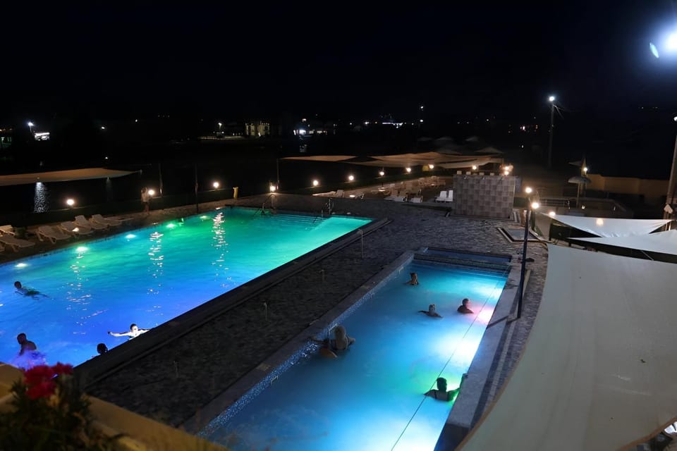 Night, Pool view, Swimming pool, group of guests, sunbed