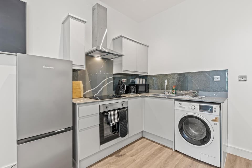 Kitchen or kitchenette, dishwasher, oven, stove, toaster, washing machine, dryer