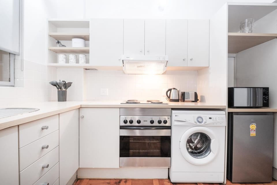 Kitchen or kitchenette, oven, stove, toaster, washing machine