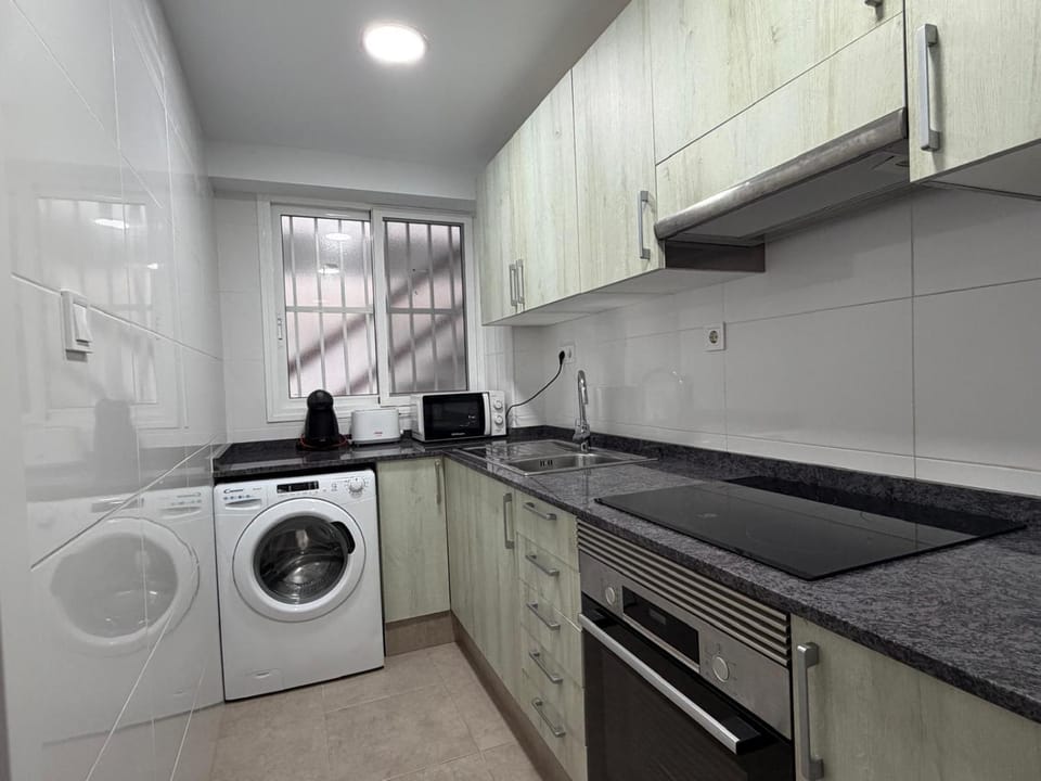 Kitchen or kitchenette, stove, washing machine
