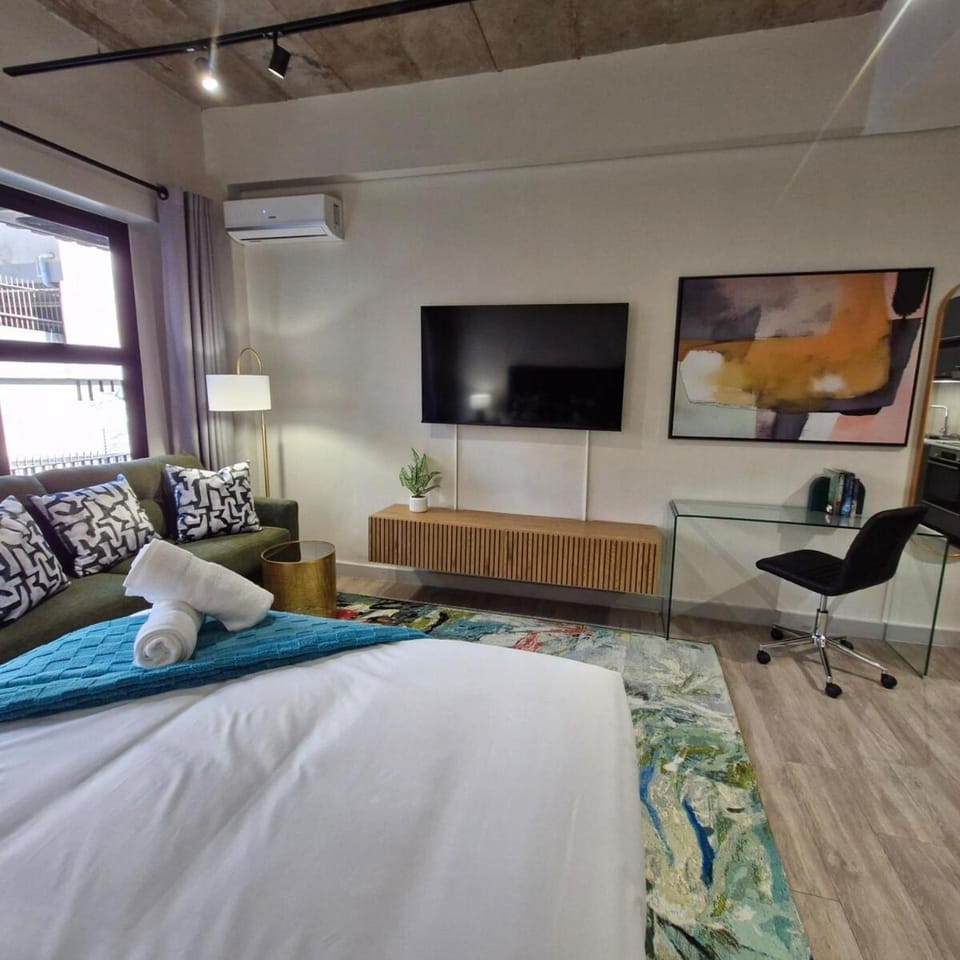 Bed, TV and multimedia, Living room, Seating area, air conditioner