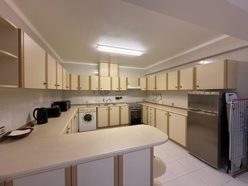 Kitchen or kitchenette, oven, stove, toaster, washing machine
