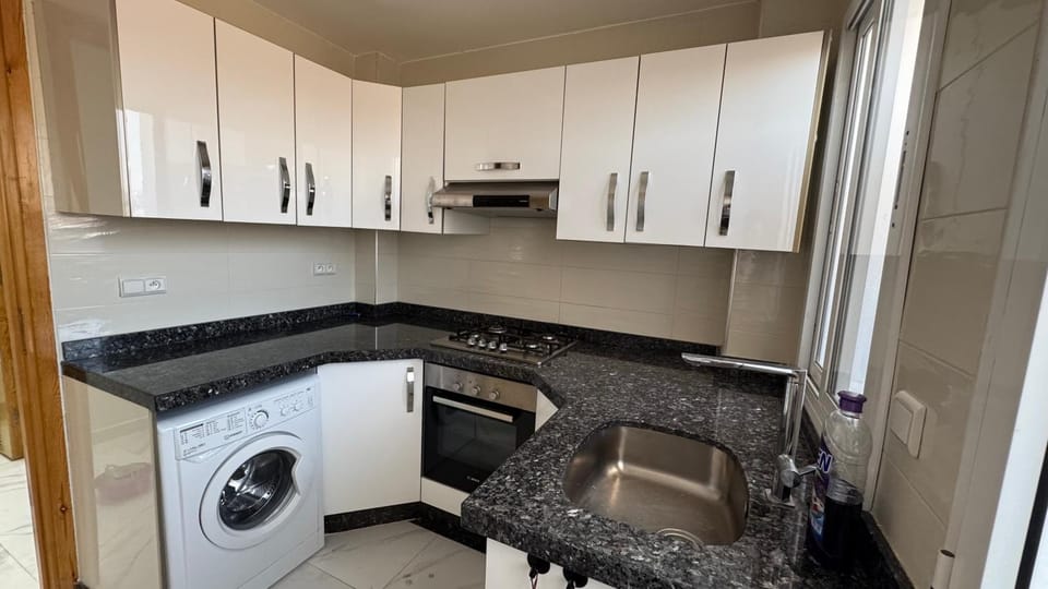Kitchen or kitchenette, stove, washing machine