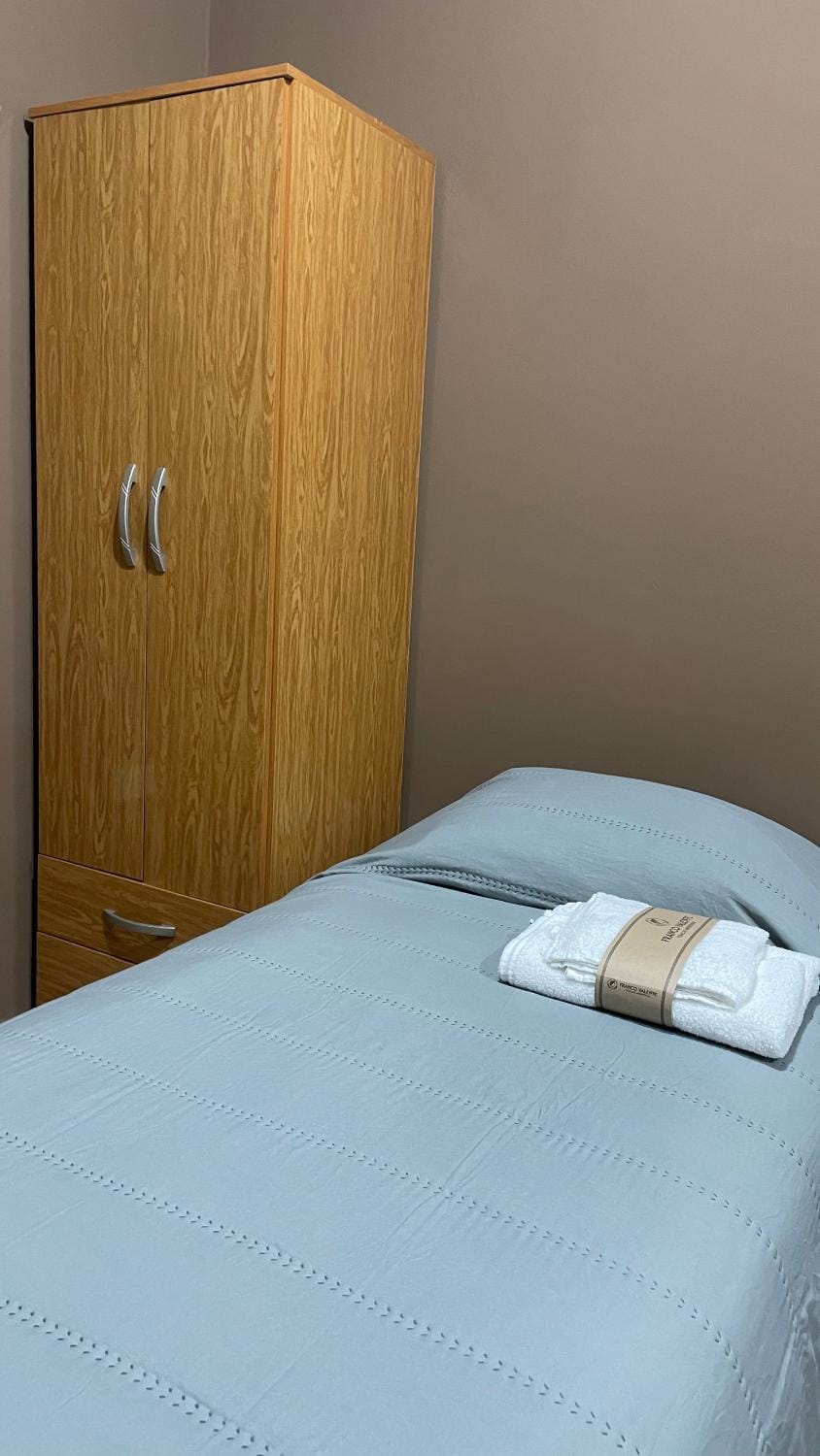 Bed, towels, wardrobe