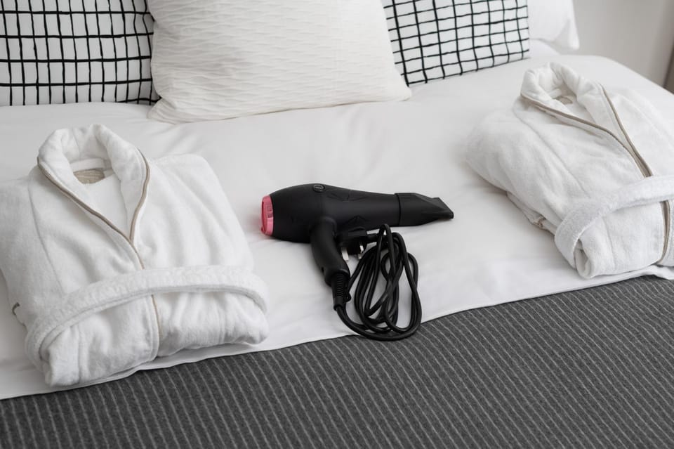 Bed, hair dryier, towels
