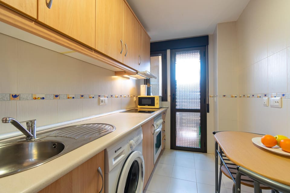 Kitchen or kitchenette, oven, stove, washing machine