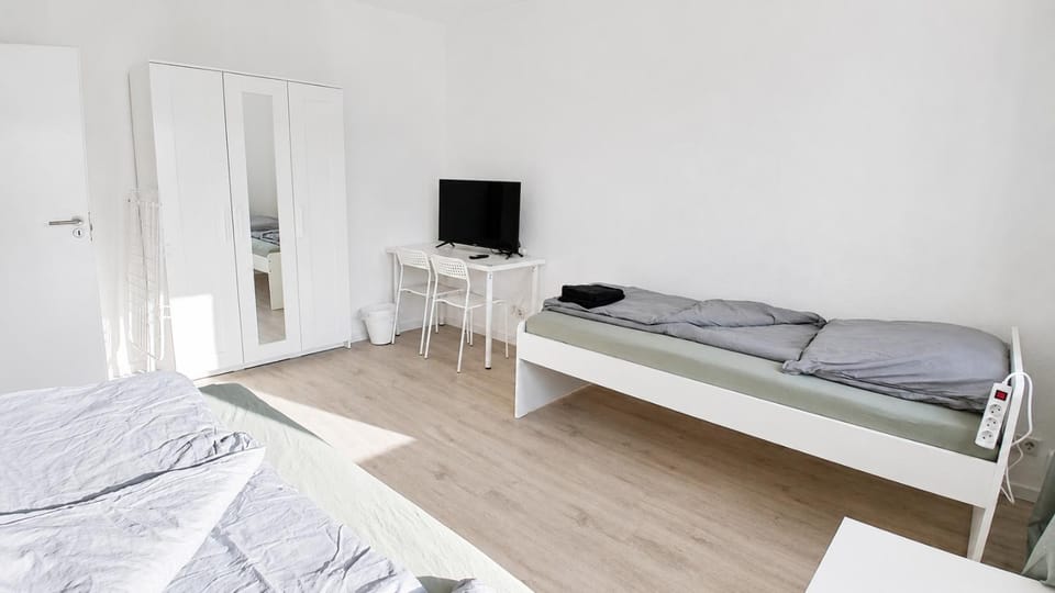 Bed, TV and multimedia, Seating area, Bedroom, towels, wardrobe