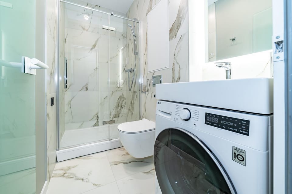 Shower, Toilet, Bathroom, towels, washing machine, dryer