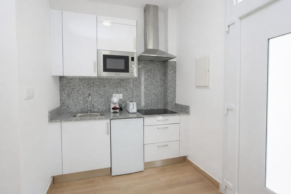 Kitchen or kitchenette, microwave, stove, toaster, kitchen
