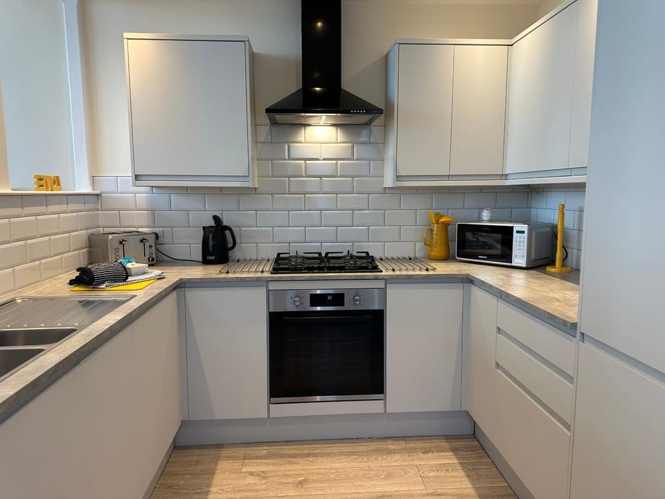 Kitchen or kitchenette, dishwasher, oven, stove, toaster