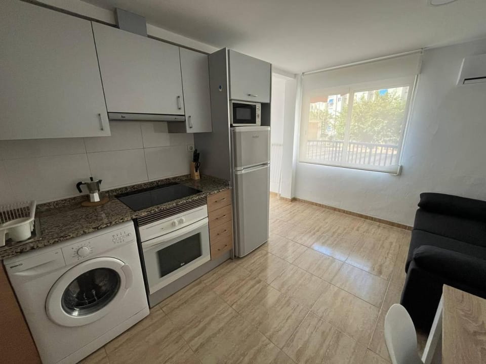 Kitchen or kitchenette, oven, stove, washing machine