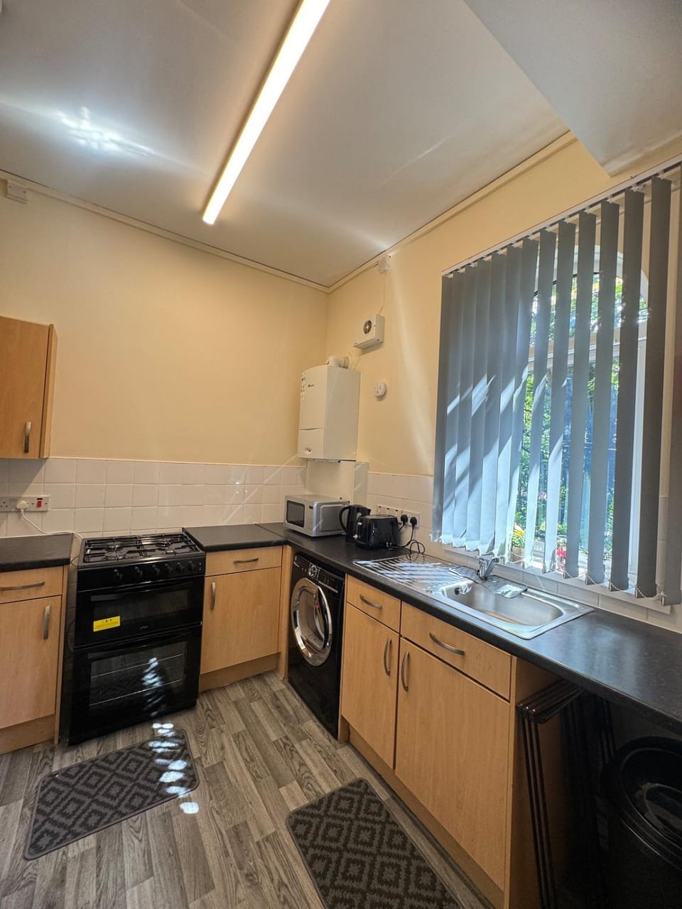 Kitchen or kitchenette, oven, stove, washing machine