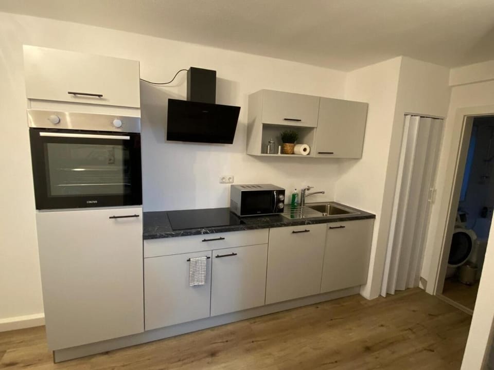 Kitchen or kitchenette, dishwasher, oven, stove