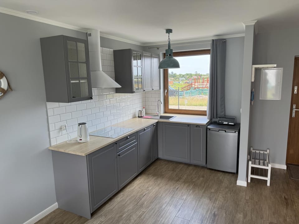 Kitchen or kitchenette, dishwasher, oven, stove