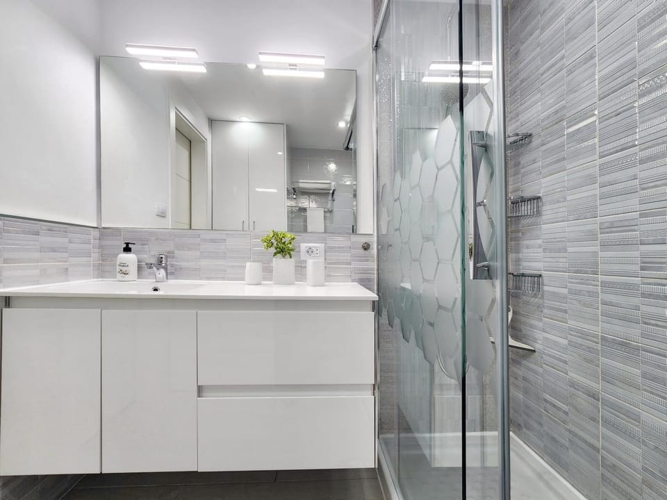 Shower, Bathroom, hair dryier, towels, washing machine