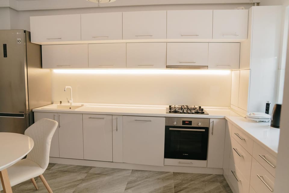 Kitchen or kitchenette, dishwasher, oven, stove