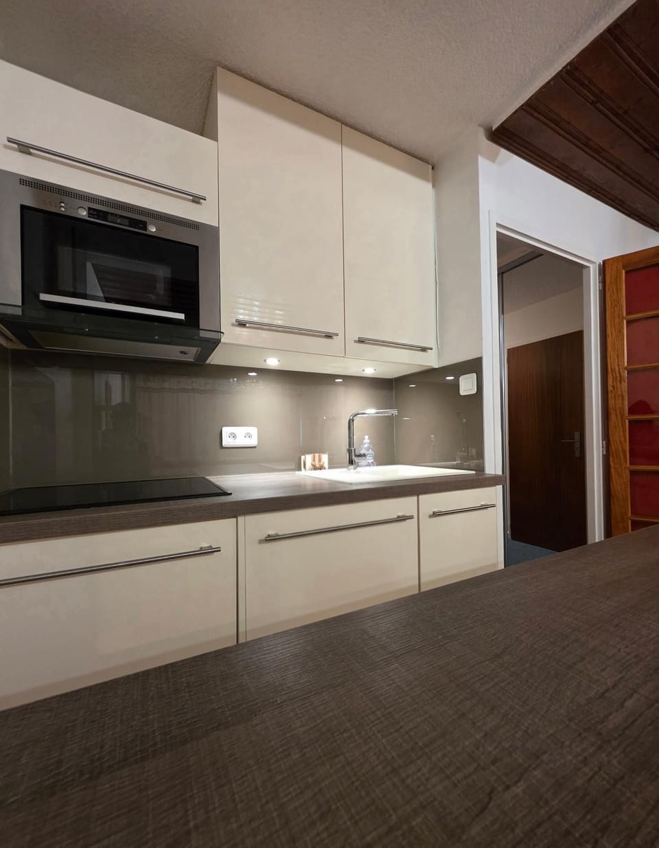 Kitchen or kitchenette, dishwasher, microwave, oven, stove