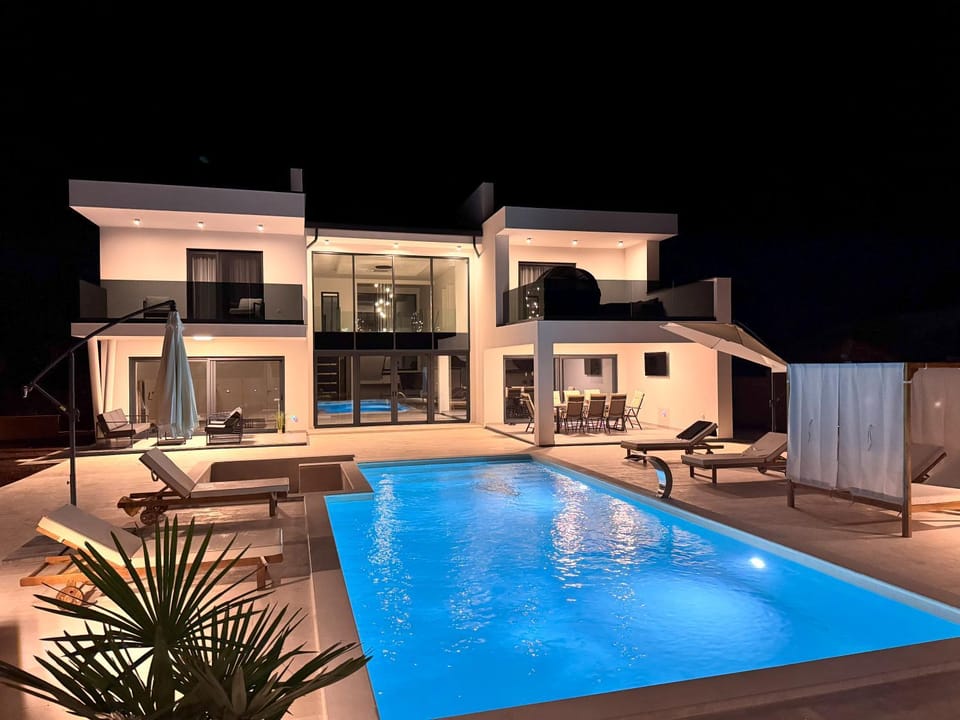 Property building, Patio, Night, Pool view, Swimming pool, Swimming pool, sunbed