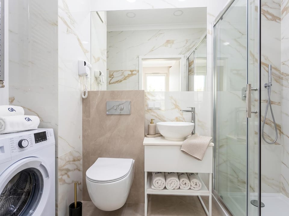 Shower, Toilet, Bathroom, bidet, towels, washing machine, dryer